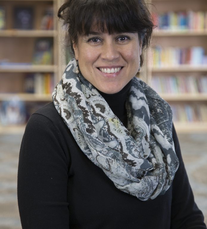 A woman wearing a black shirt and a scarf.