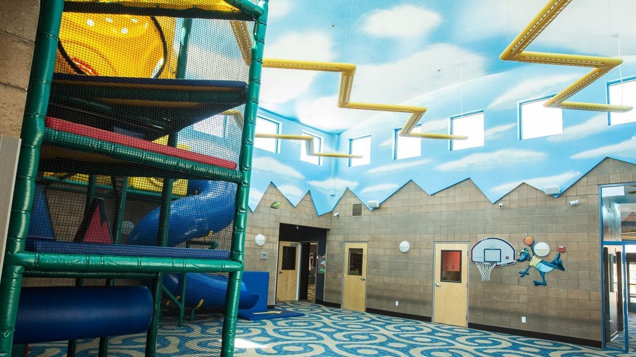 A playground with slides and a slide house.