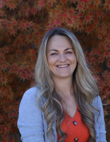 Smiling woman with long hair in autumn.